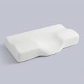 Almohada cervical mariposa de espuma viscoelástica Mariposa, sobre fondo liso de estudio
